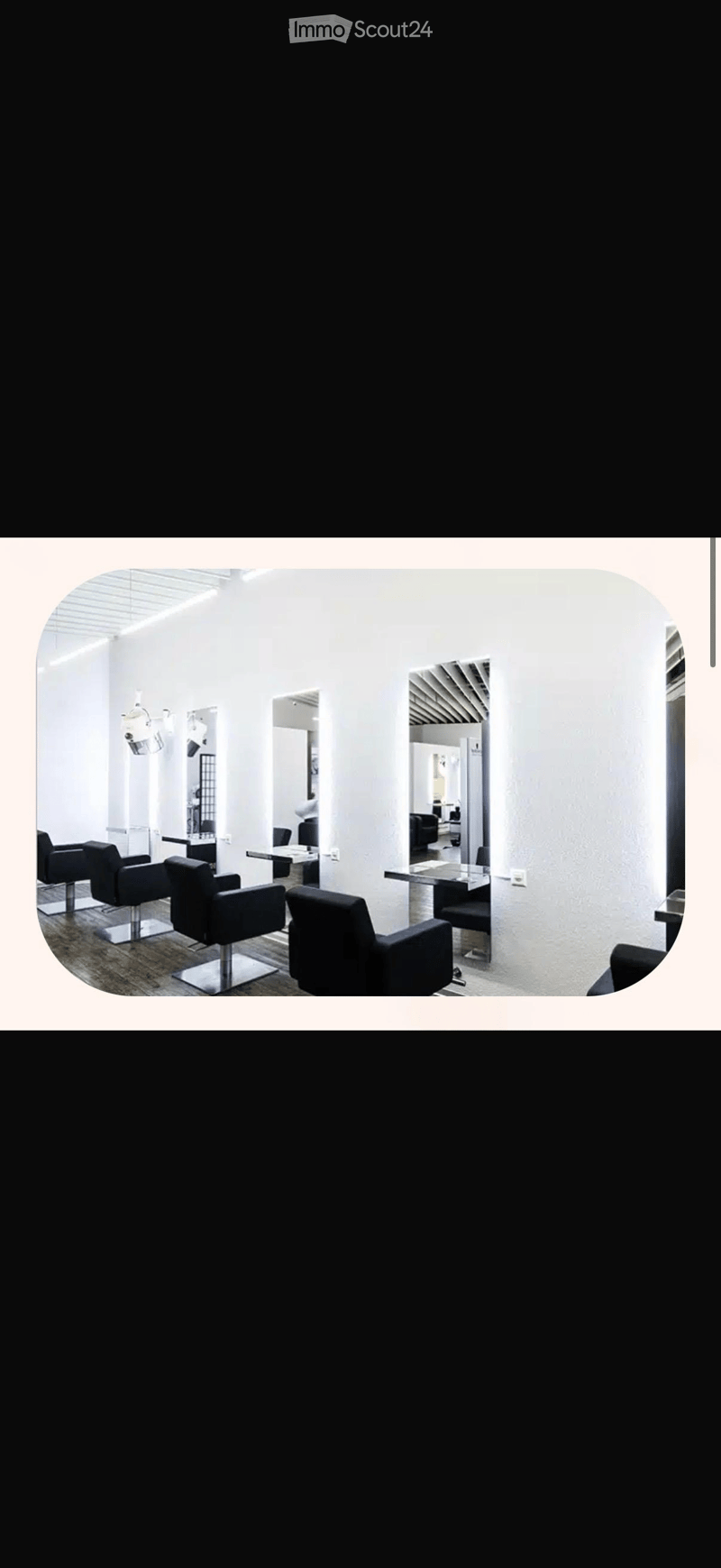 modern salon with white walls, black chairs, mirrors, tables, and ceiling lights