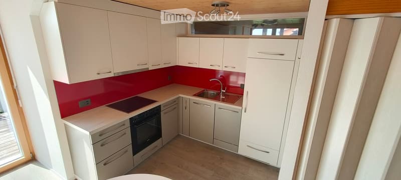 modern kitchen, white cabinets, red wall, induction stove, dishwasher, sink, wooden floor
