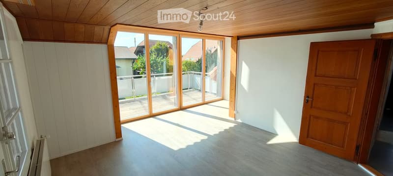 empty room, wooden floor, white walls, large glass doors, balcony