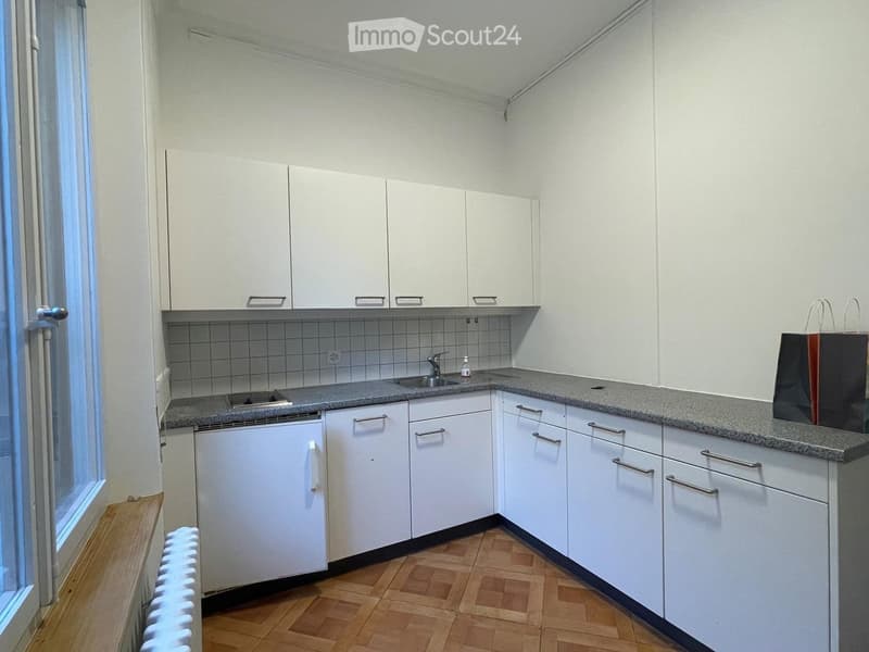 modern kitchen with white cabinets, gray countertop, sink, faucet, dishwasher, and a window