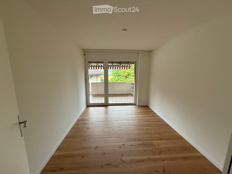 empty room, wooden floor, white walls, sliding glass doors, balcony