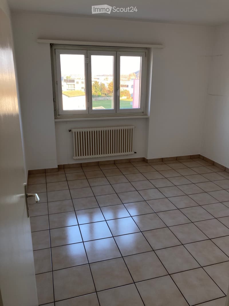 empty room, white walls, tiled floor, window with view, white radiator