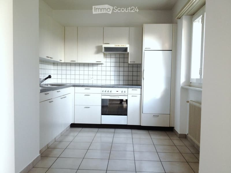 modern kitchen with white cabinets, tiled floor, stainless steel sink, oven, refrigerator, and a window
