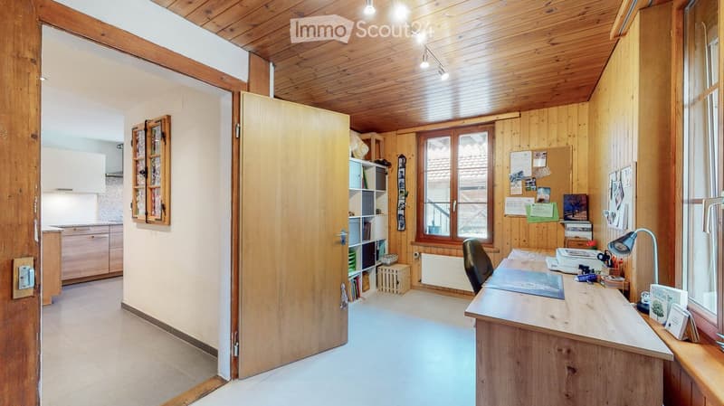 wooden walls, wooden floor, desk, chair, shelves, radiator, window, bulletin board