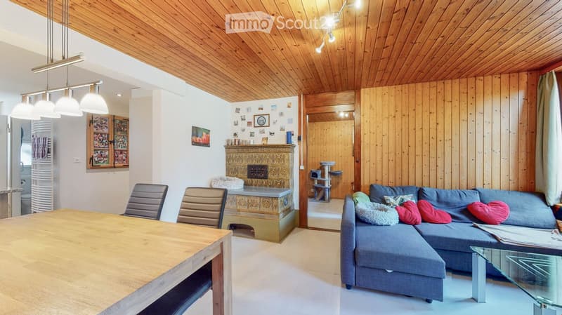 wooden ceiling, fireplace, wooden table, couch, glass table, chairs