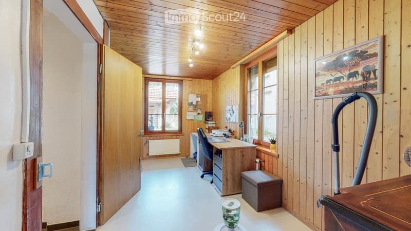 wooden walls, wooden floor, desk, chair, radiator, picture frame, window, door