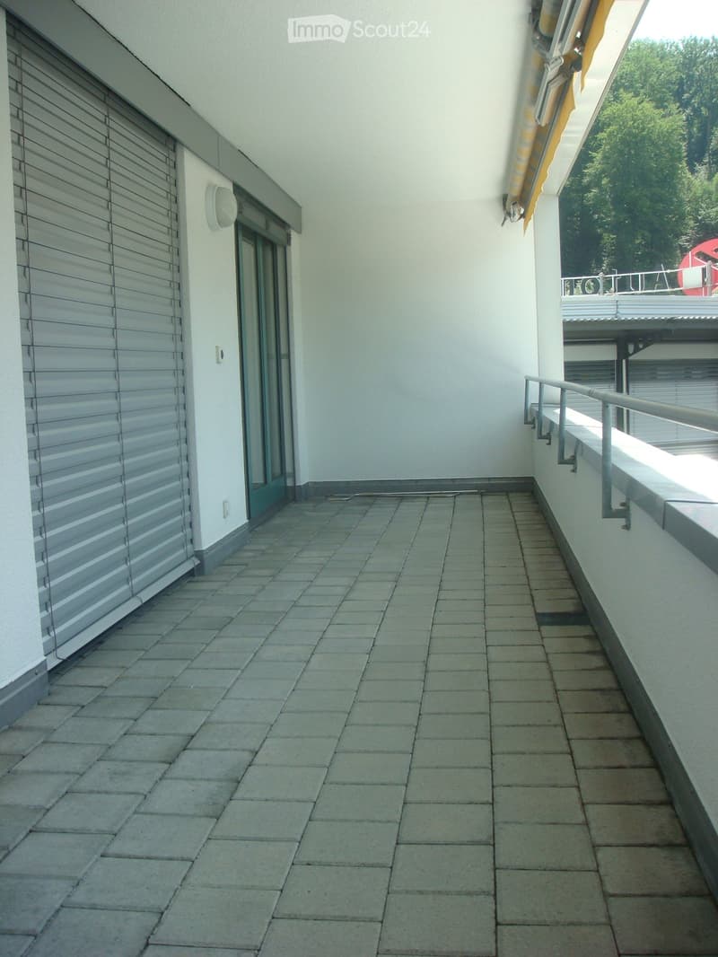 tiled floor, metal railing, closed door, closed window, light on wall