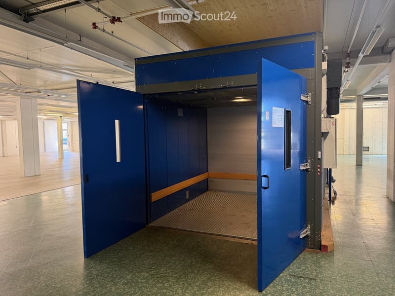 large blue door, metal floor, empty room