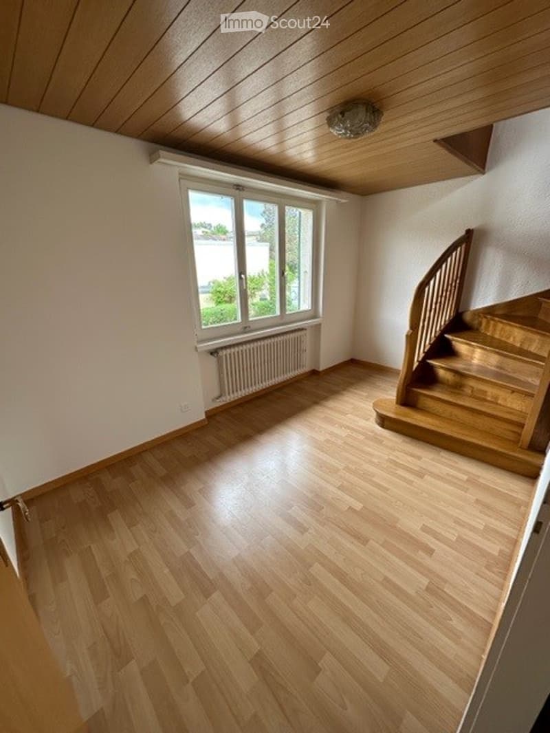 empty room, wooden floor, white walls, wooden staircase, window with white frame, white radiator