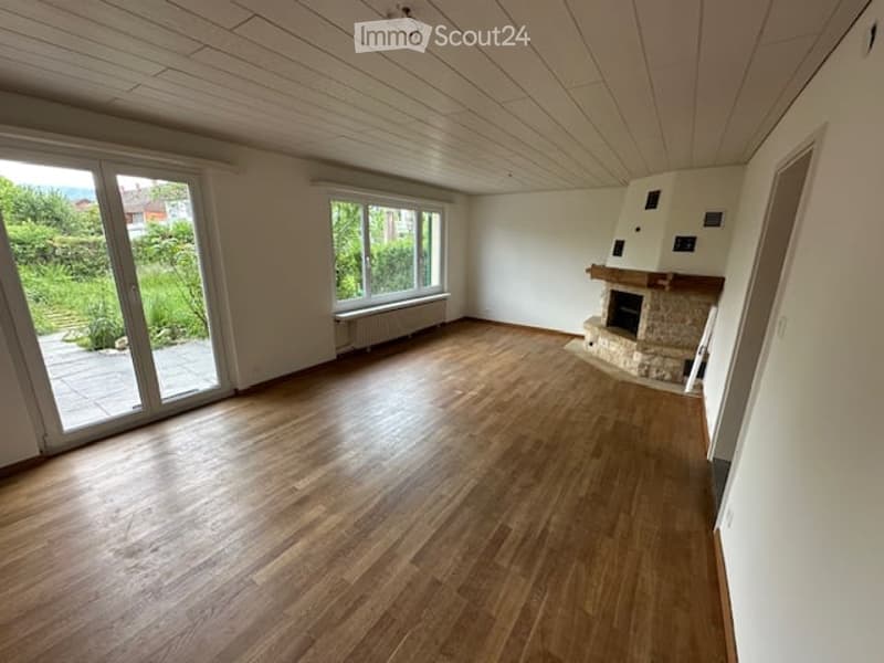 empty room, wooden floor, white walls, fireplace, sliding glass doors, windows