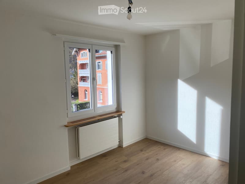 empty room, white walls, wooden floor, white radiator, large window