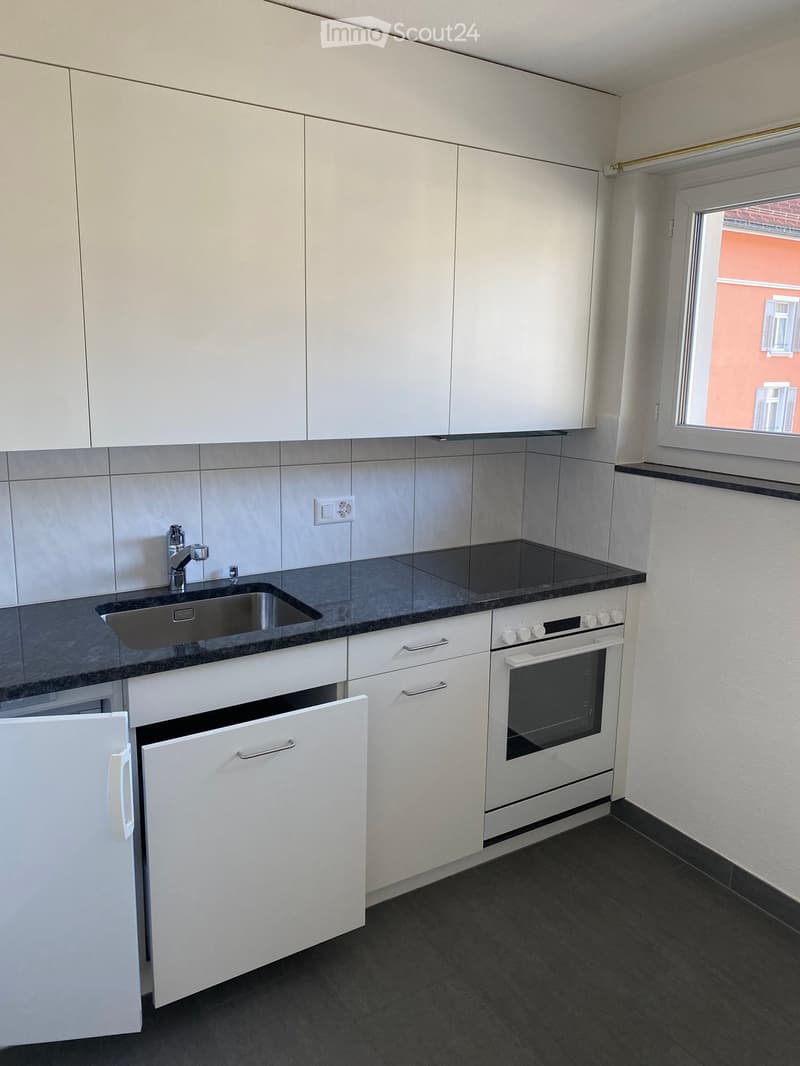 modern kitchen with white cabinets, granite countertop, stainless steel sink, electric oven, window