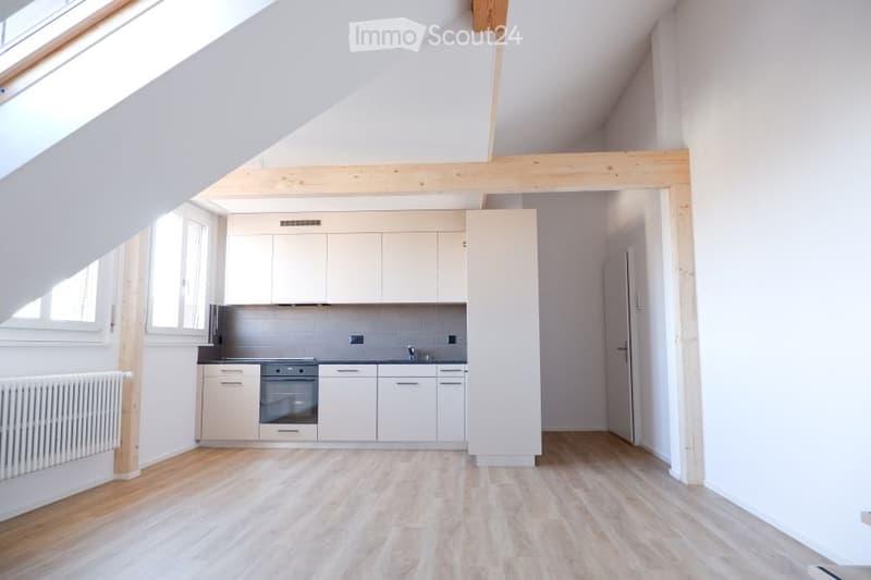 modern kitchen with white cabinets, wooden beams, wooden floor, white walls, windows, radiator