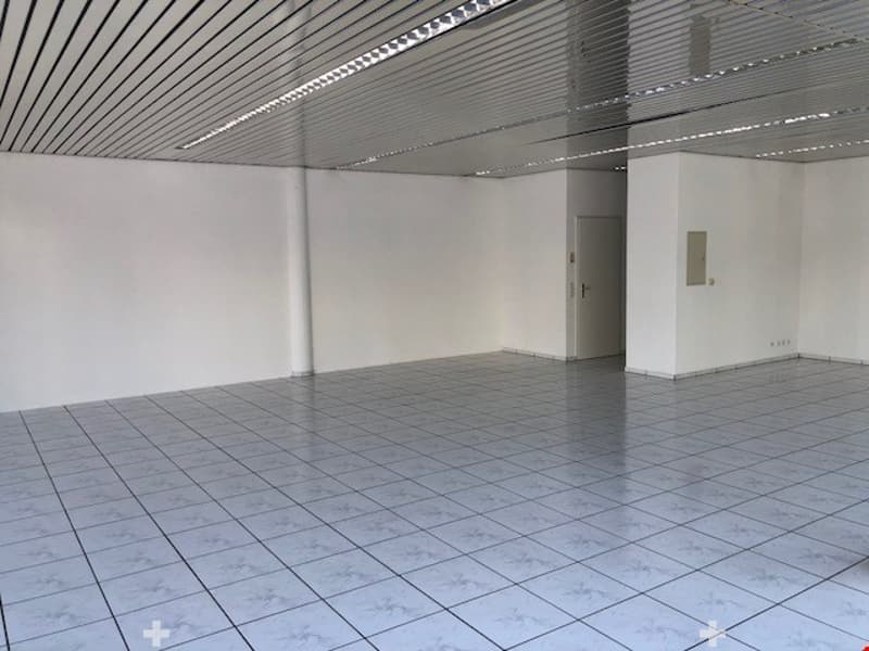 empty room, white walls, white tiles, metal ceiling, door, power outlet