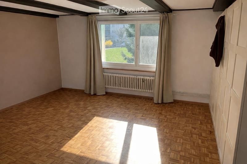 empty room, wooden floor, white walls, large window, curtains, radiator