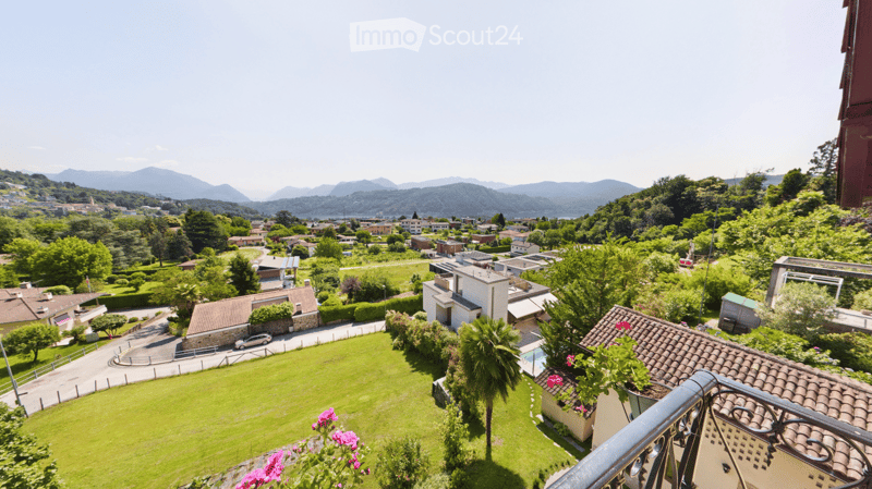 Houses, green lawn, mountains in the background, swimming pool