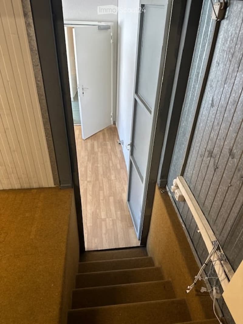 wooden floor, white walls, open doors, carpeted steps