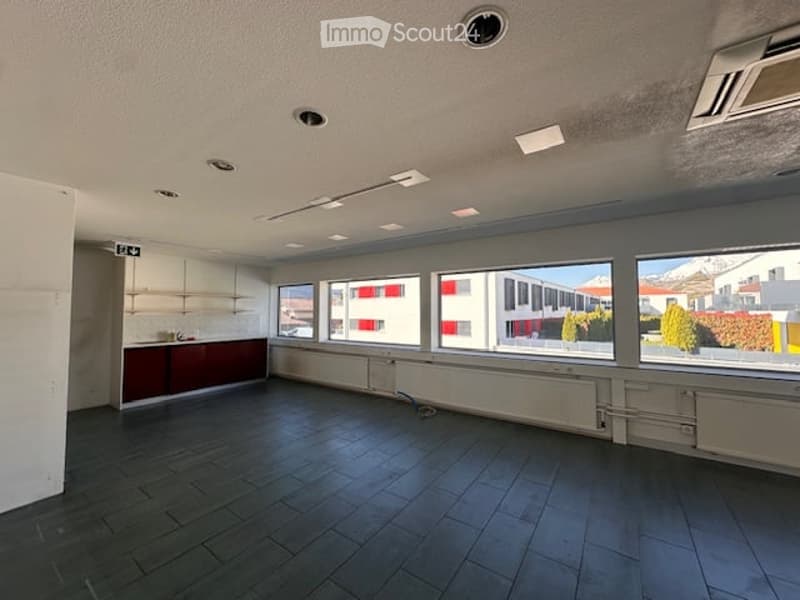 empty room, tiled floor, large windows, white walls, ceiling lights, radiators, cabinets