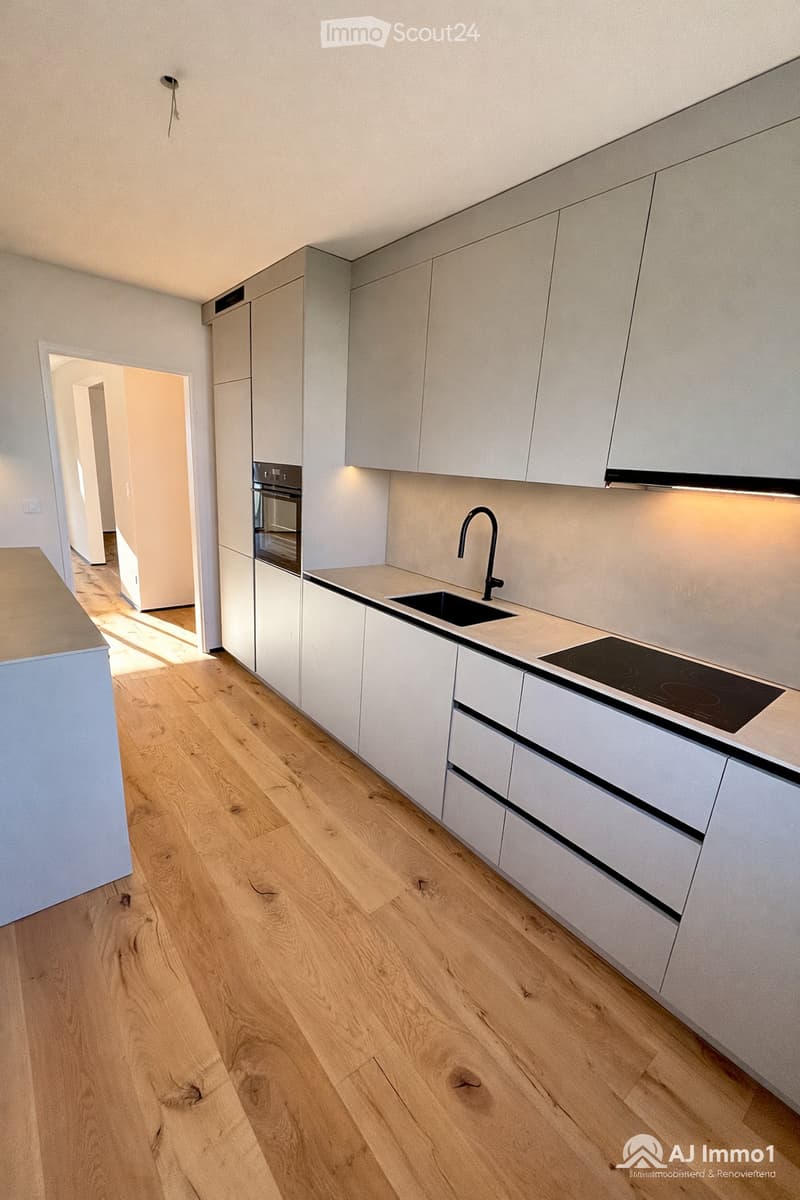 modern kitchen, white cabinets, wooden floor, black sink, black faucet, black stove, black induction hob