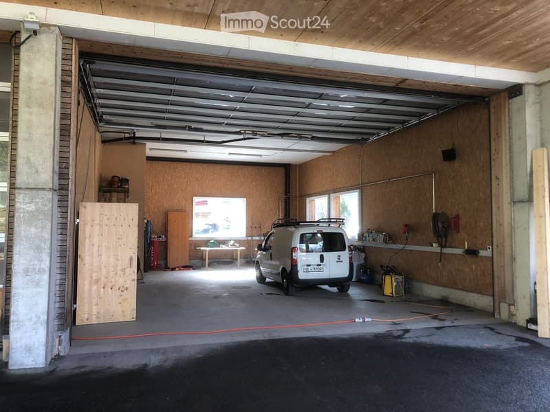 white van parked, wooden door, wooden ceiling, wooden walls, shelves, table, tools
