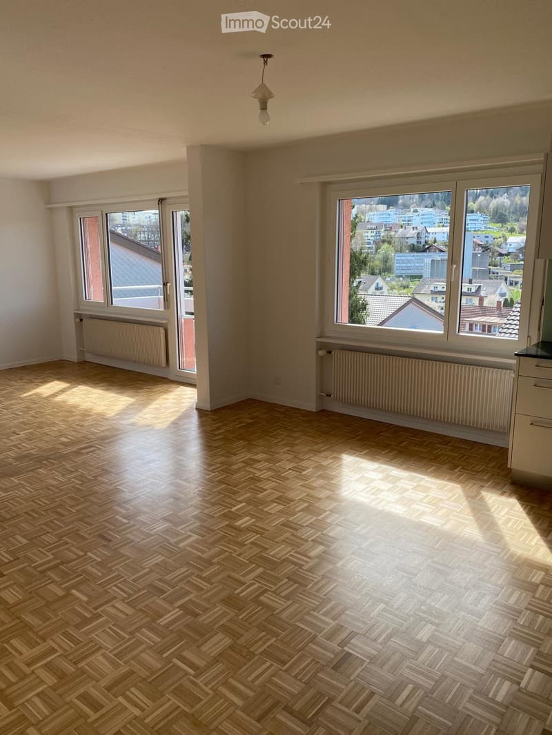 empty room, wooden floor, white walls, large windows, radiators, sliding doors