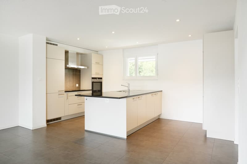 Kitchen. Modern kitchen with white cabinets, a central island, and stainless steel appliances. Features include a sink with a modern faucet, an oven, and ample cabinet space.