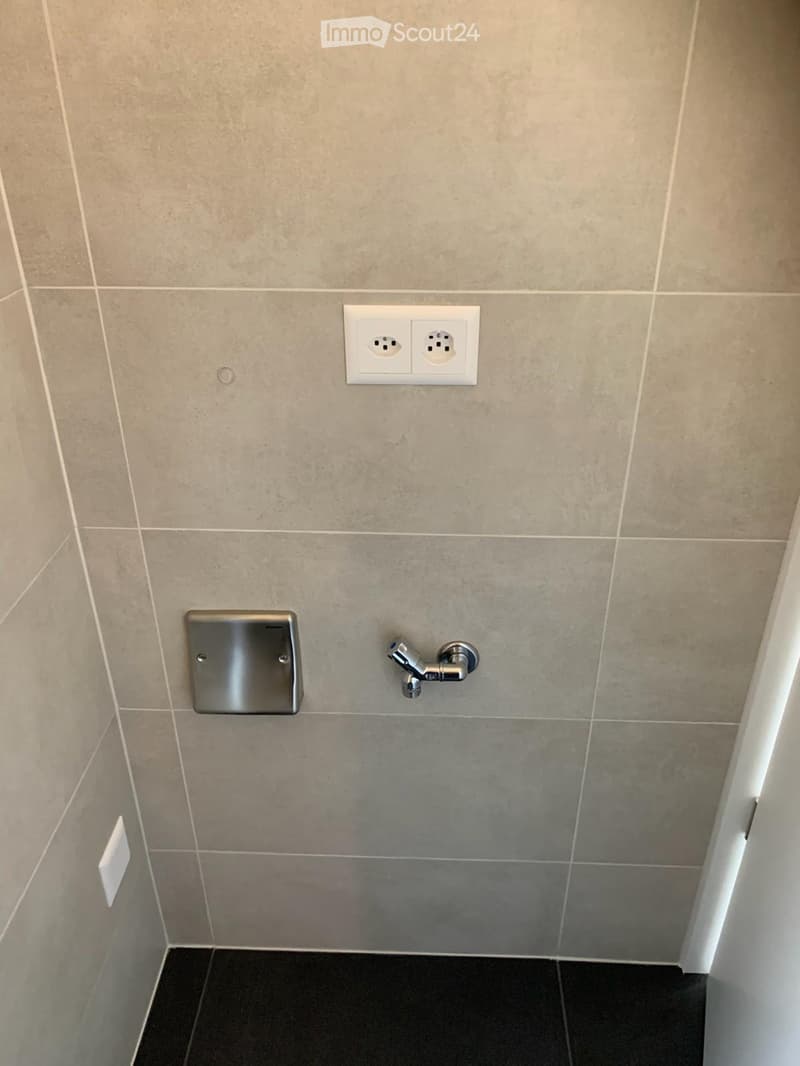 tiled walls, tiled floor, power outlet, metal faucet, metal soap dispenser