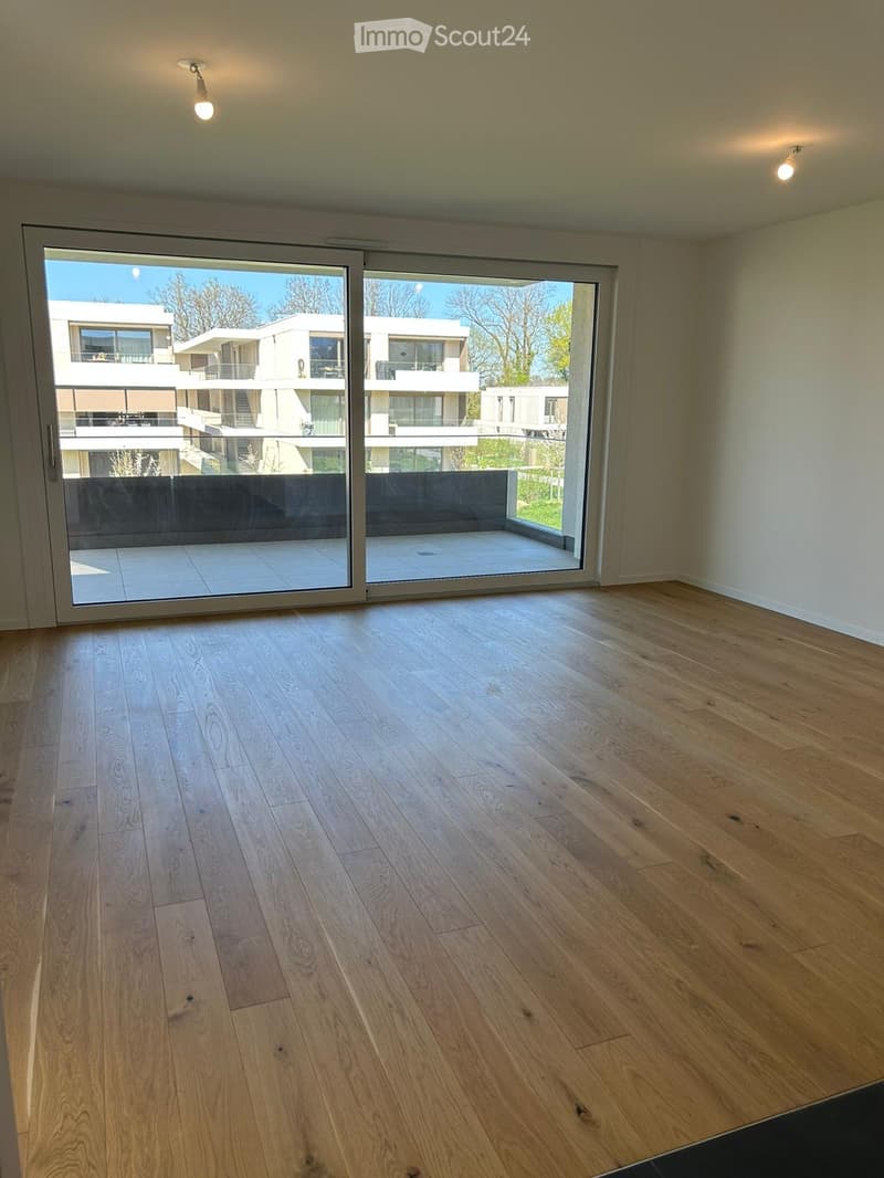 empty room, hardwood floors, sliding glass doors, balcony, white walls