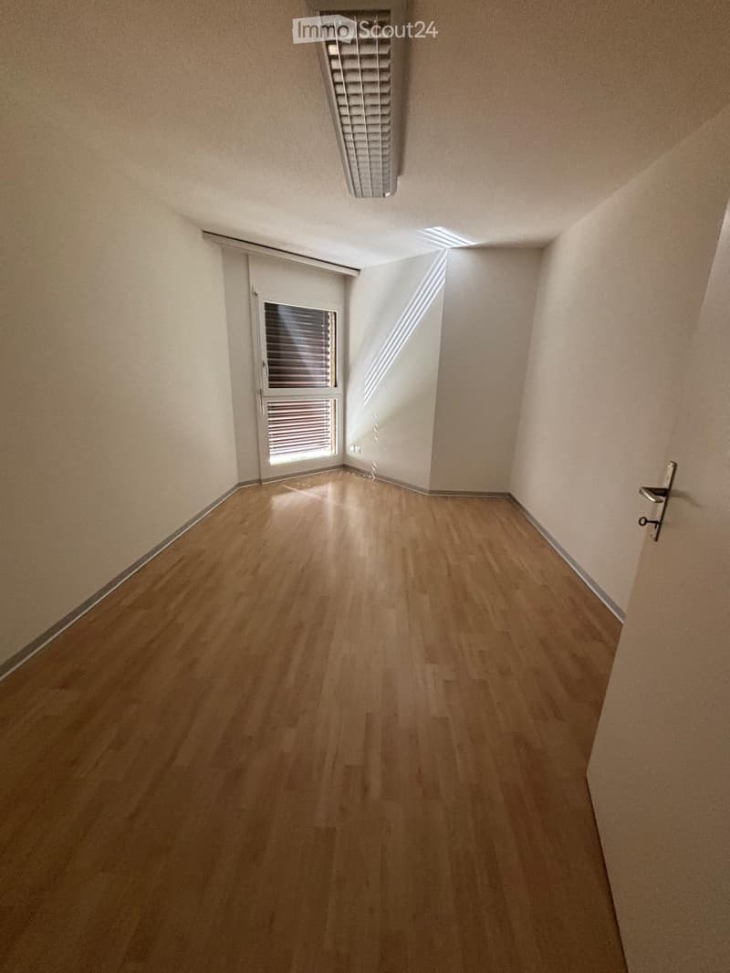 Empty room with wooden flooring, white walls, and a window with blinds. No furniture or equipment is present.
