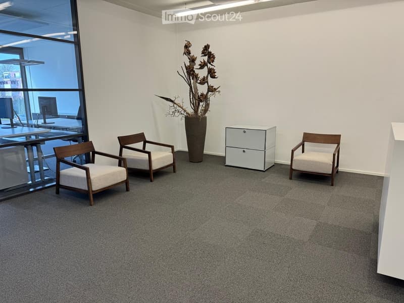 empty room with 3 chairs, a cabinet, a flower vase, and a glass wall