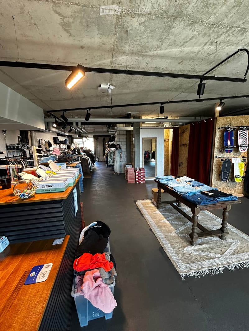 clothing store, clothing racks, wooden tables, boxes, storage boxes, lamps, skateboards