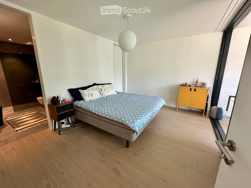 Bedroom with bed, nightstand, cabinet, rug, and a balcony
