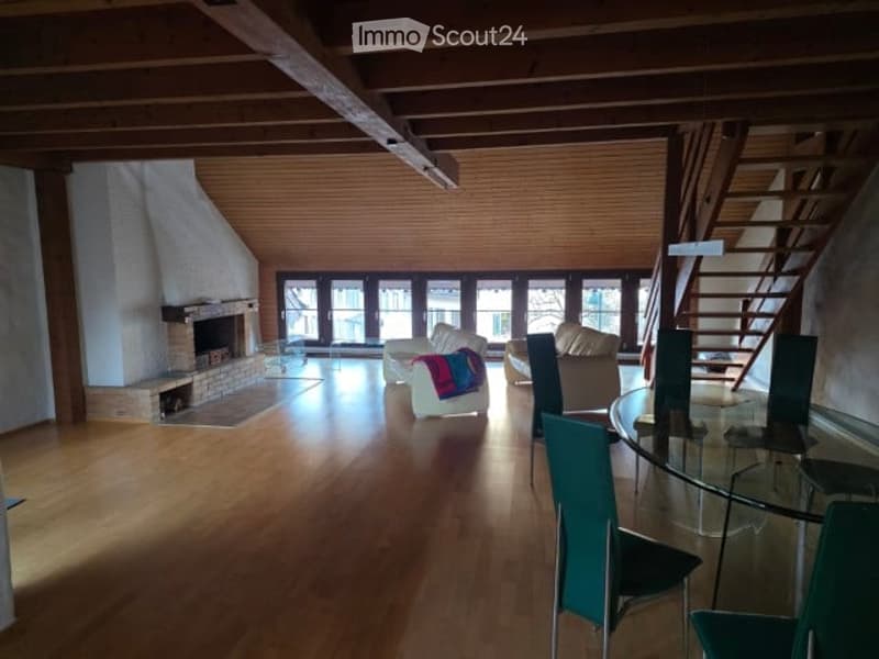 wooden floor, wooden ceiling, fireplace, glass table, chairs, couch, staircase
