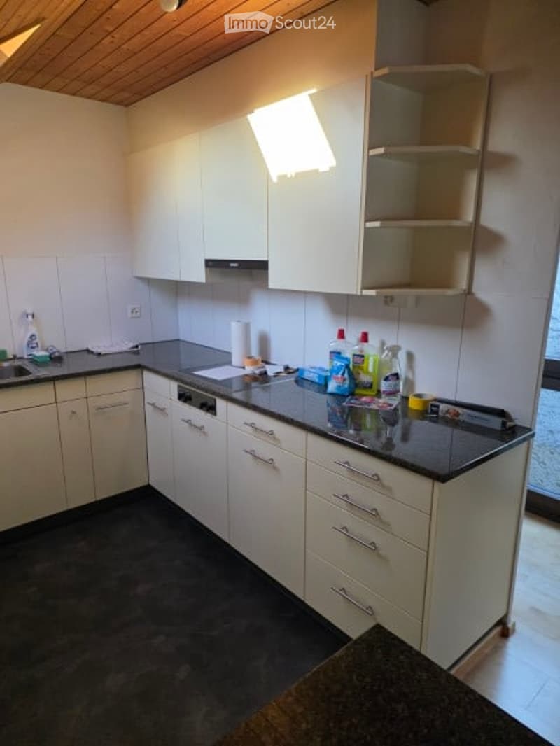 kitchen with white cabinets, black countertops, white tiled walls, wooden ceiling, sink, dishwasher