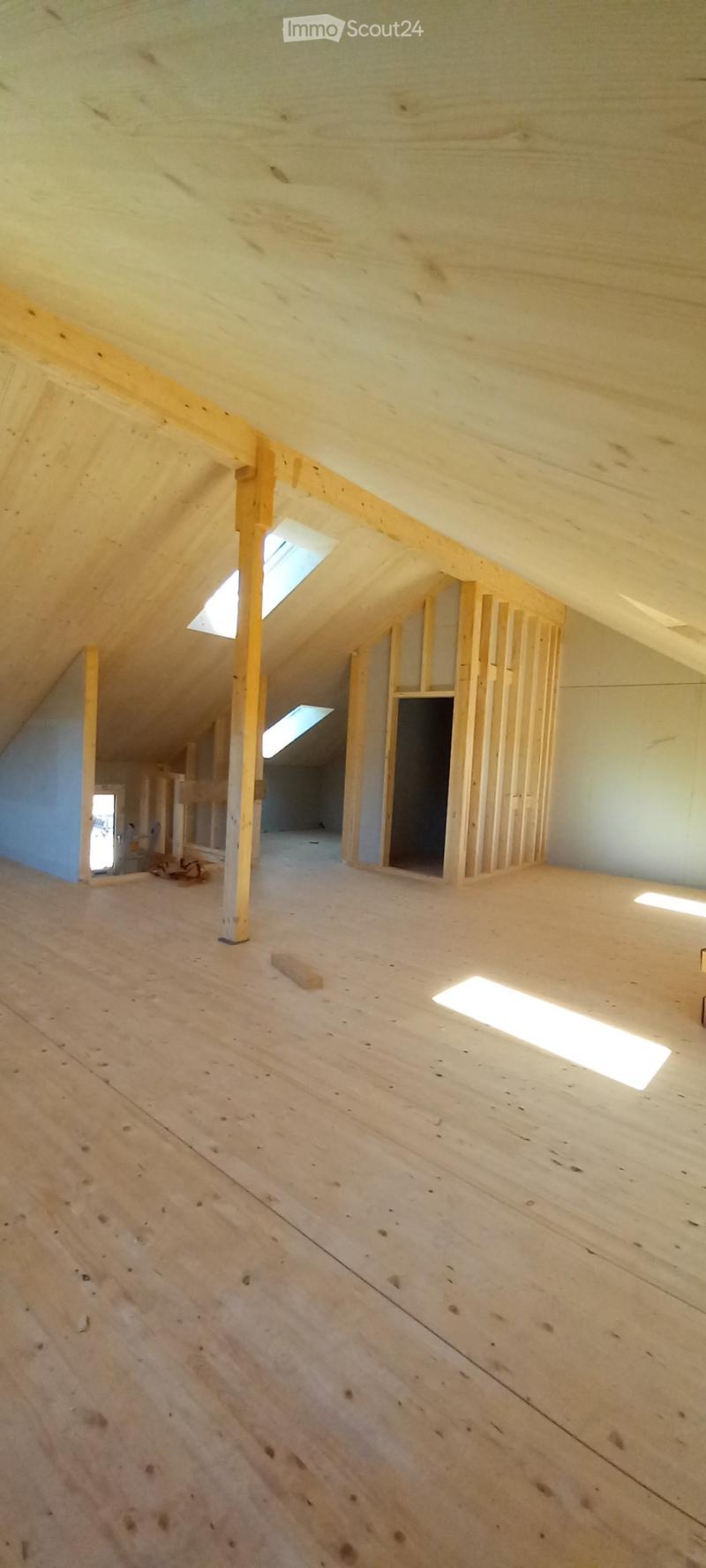 unfinished attic room, wooden beams, wooden floor, skylights