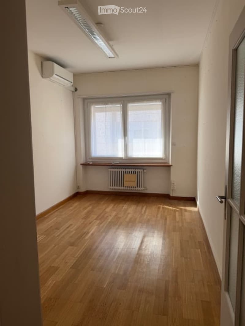 empty room, wooden floor, white walls, window, radiator, air conditioner