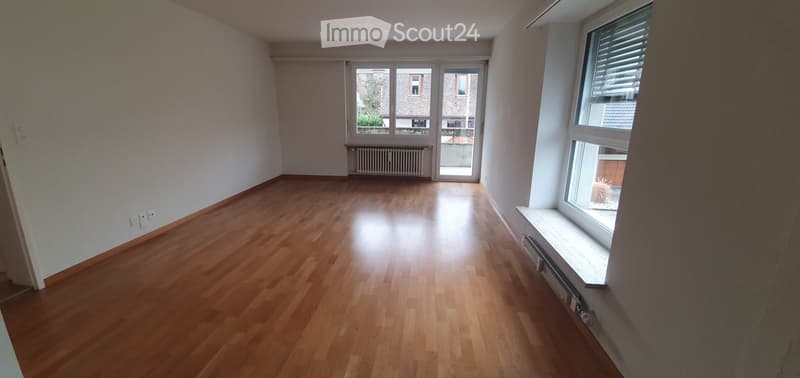 empty room, wooden floor, white walls, sliding glass door, windows, radiators
