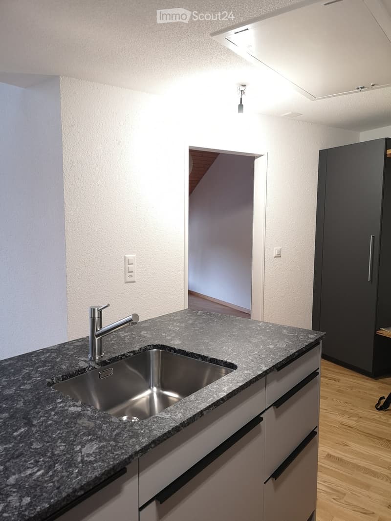 kitchen with granite countertop, stainless steel sink, faucet, white cabinets, wooden floor