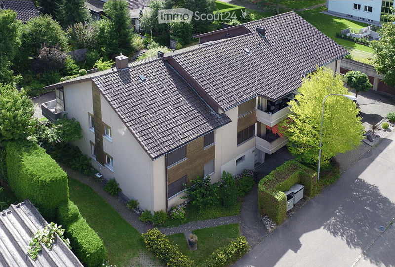 2 story house, brown roof, white walls, balconies, windows, garden, driveway