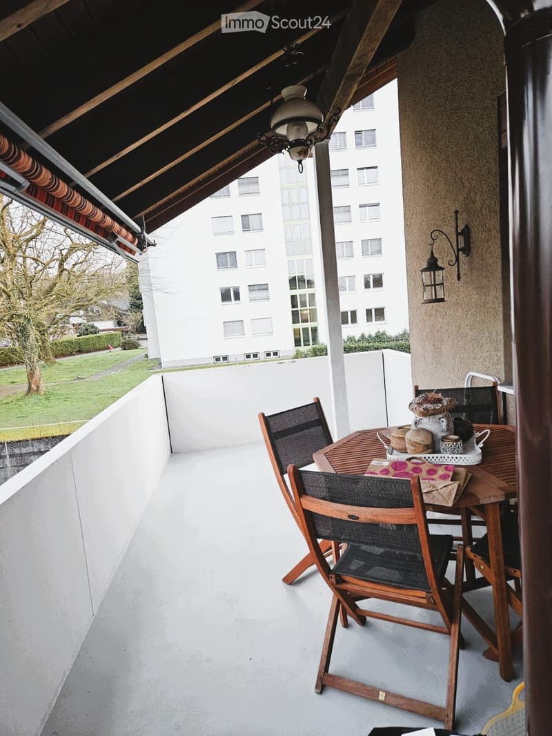 Balcony with table and chairs, lamp, wall lamp, view of the building and tree