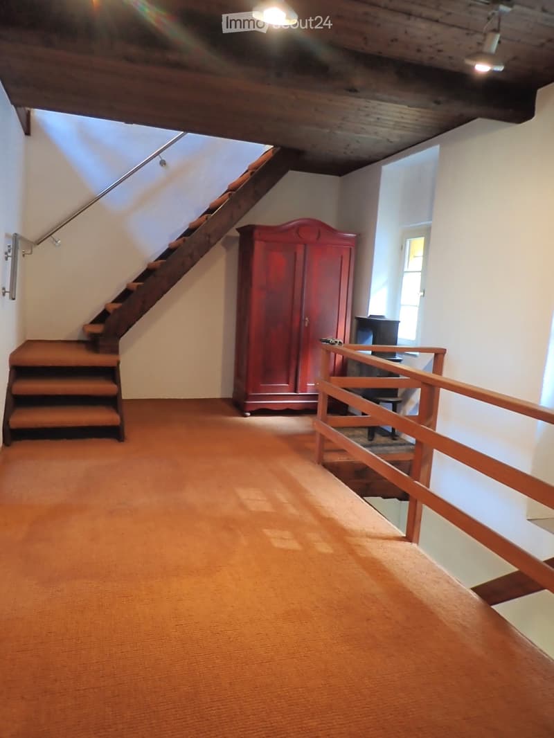 empty room, wooden floor, wooden stairs, wooden cabinet, wooden railing, white walls, ceiling lights