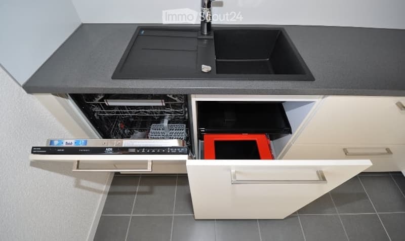 Dishwasher under the sink, countertop, sink, cabinet drawers