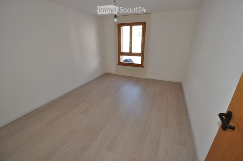 empty room, hardwood floor, large window, white walls, open door