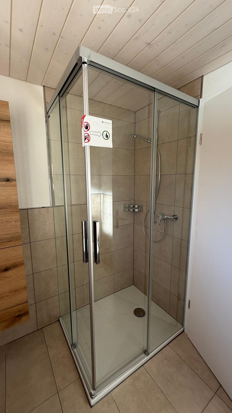 shower stall, glass walls, tiled floor, wooden wall, shower head, drain