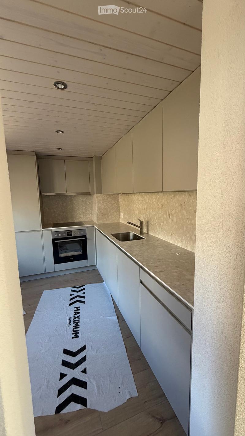 modern kitchen with white cabinets, granite countertop, stainless steel sink, oven, dishwasher, washing machine