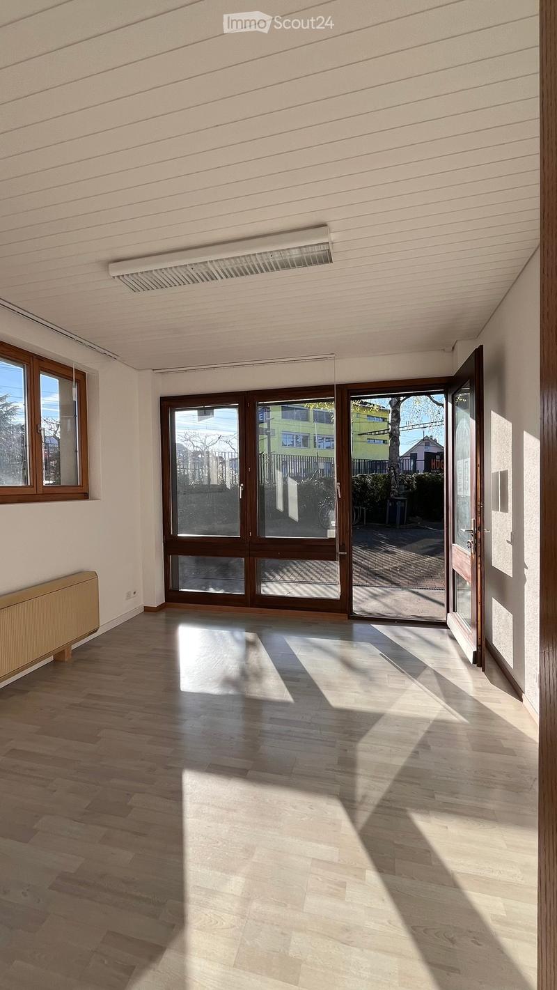 empty room, wooden floor, large windows, sliding doors, white walls, radiator