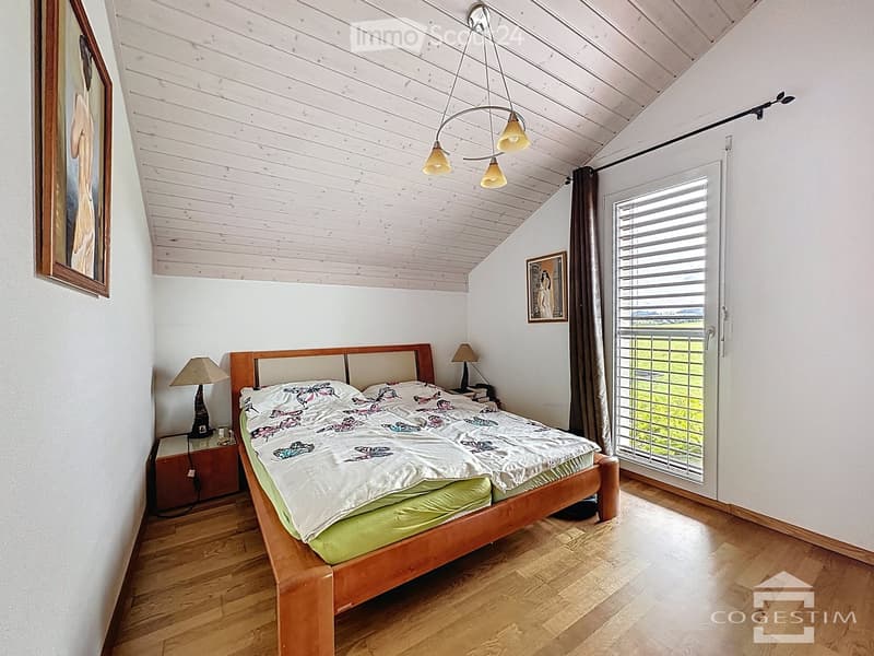 bedroom with wooden bed, wooden nightstands, lamps, picture frames, wooden ceiling, sliding glass door, view of the field