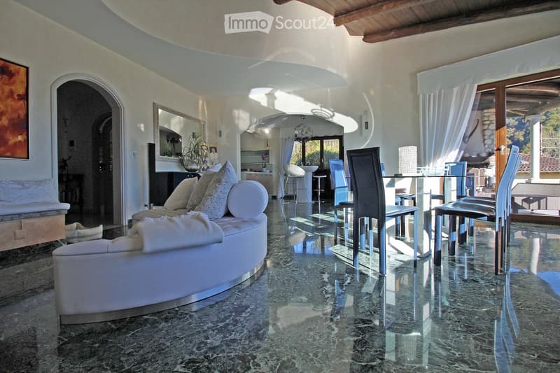 modern living room with white couch, marble floor, dining table, glass doors, large windows