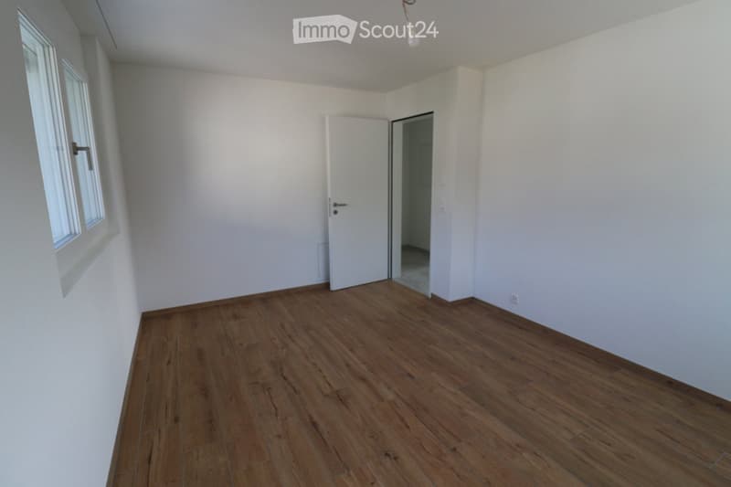 empty room, white walls, wooden floor, window, door, power outlet
