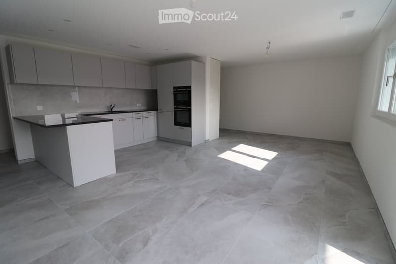 modern kitchen with white cabinets, black countertops, built-in oven and sink, tiled floor